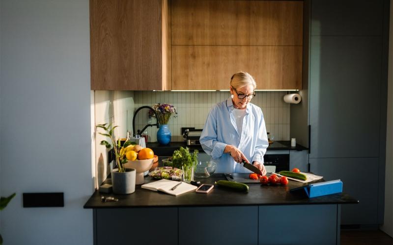 a woman cutting vegetables in the kitchen