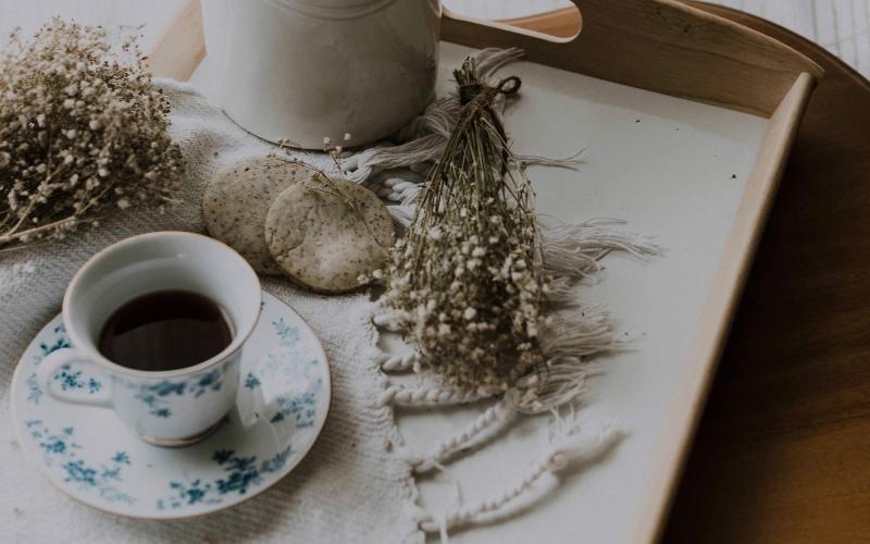 tea and cookies on a serving tray with baby's breath